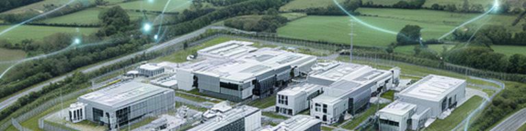 Aerial view of a UK data centre campus with secure server buildings and connected regional routes